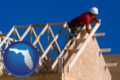 florida map icon and a carpenter building a house, working on roof joists